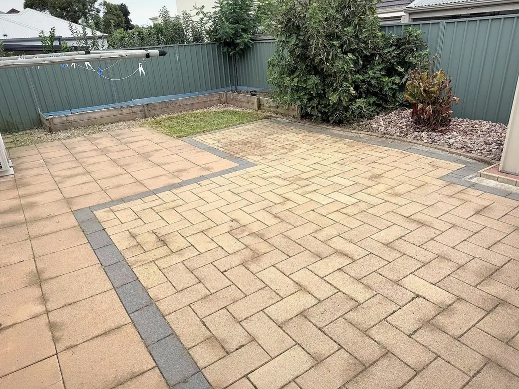 A herringbone paved backyard tidied up with edges and garden sorted